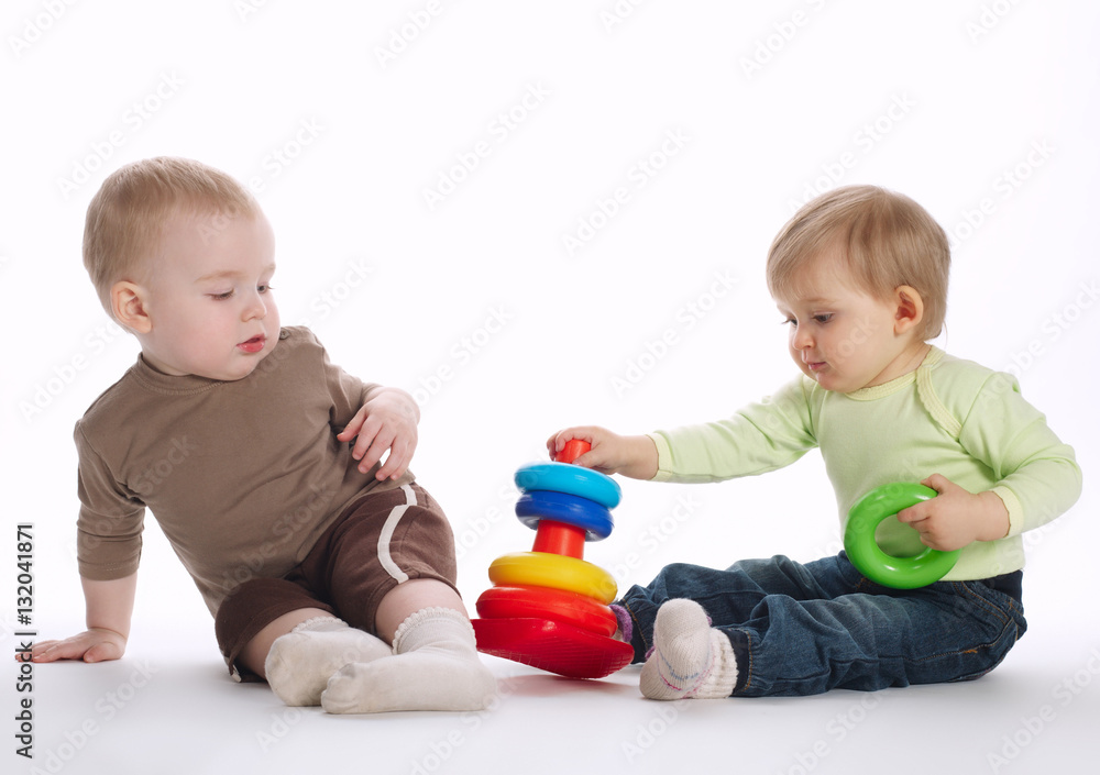two beautiful children playing with pyramide two beautiful children playing with pyramide