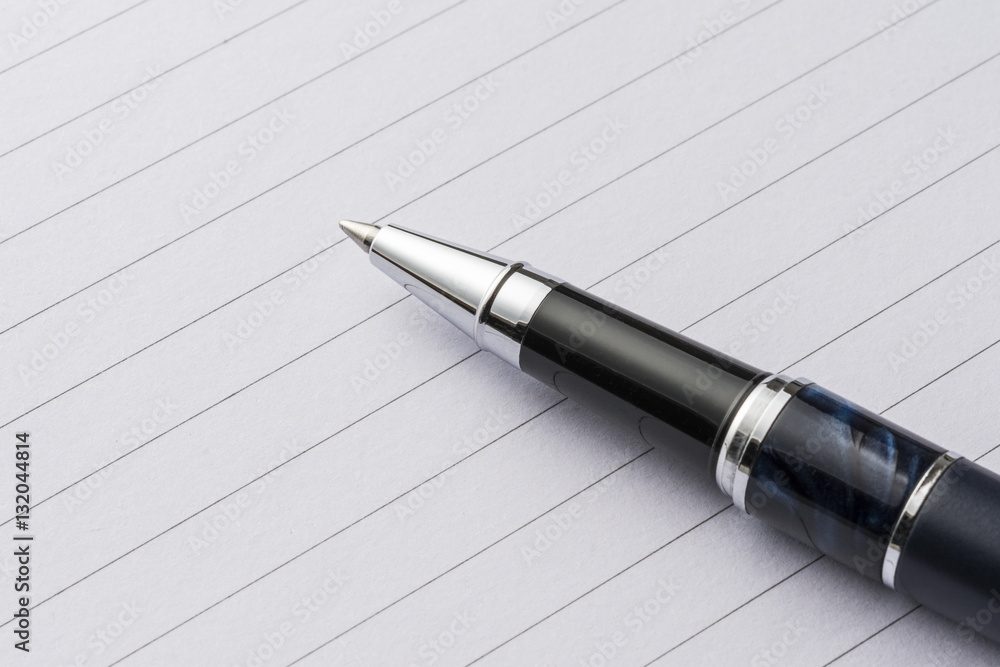 elegant metal pen on a sheet of paper elegant metal pen on a sheet of paper