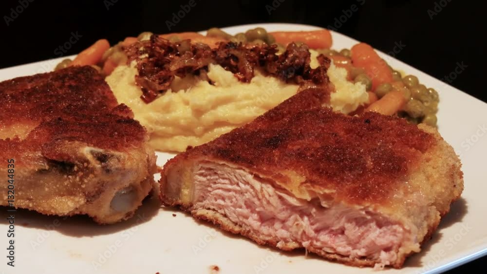 A breaded veal cutlet with mashed potatoes, roasted onions and peas and carrots. 4k 11841
A breaded veal cutlet with mashed potatoes, roasted onions and peas and carrots. 4k 11841