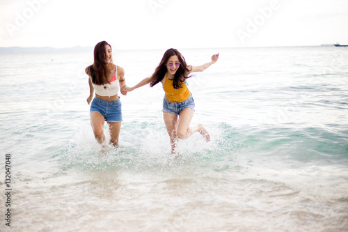 Two friend are having fun on the beach