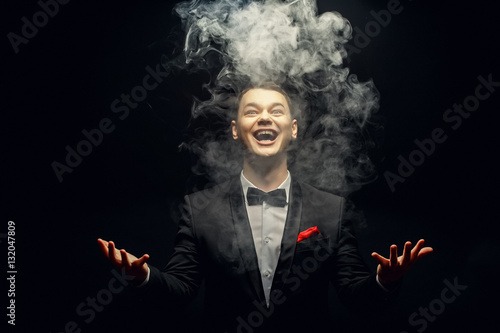 Emotion young Magician playing with Magic smoke