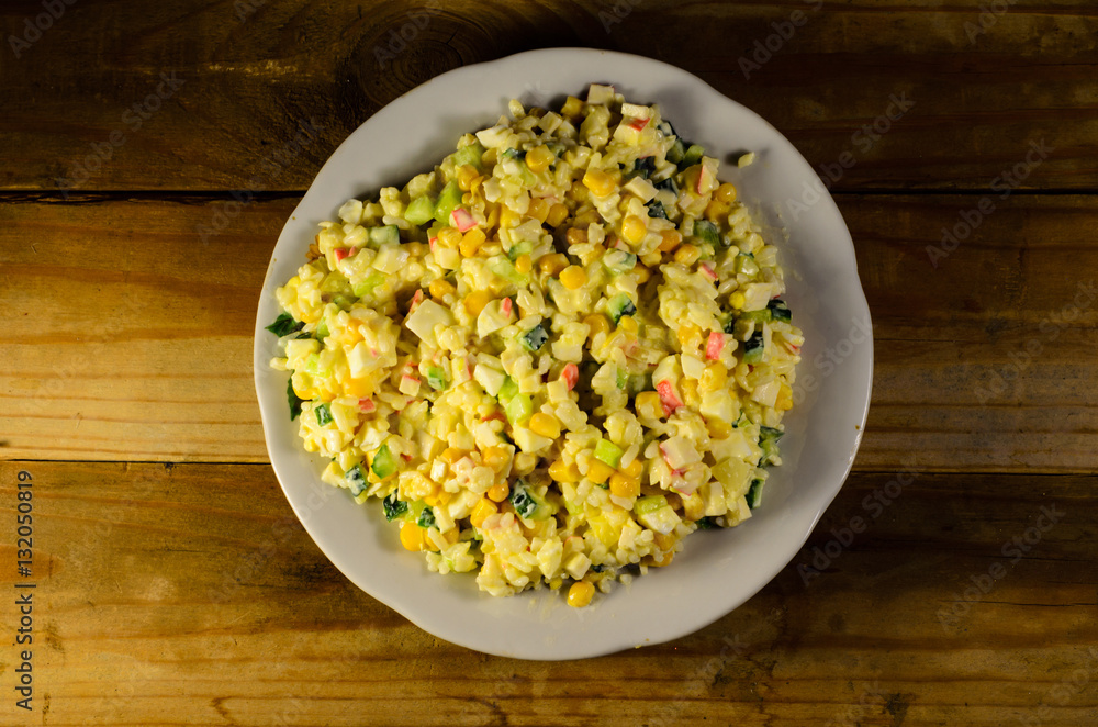 Salad with crab sticks, corn, cucumber, and eggs Salad with crab sticks, corn, cucumber, and eggs