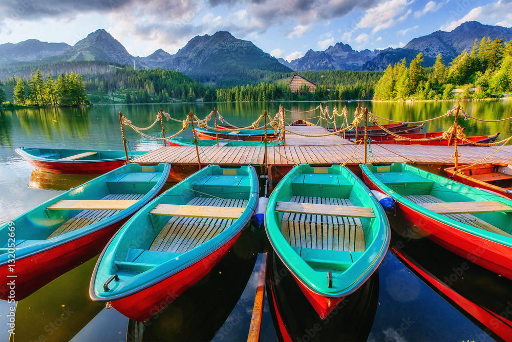 Boat on the dock surrounded mountains. Fantastic Shtrbske Pleso