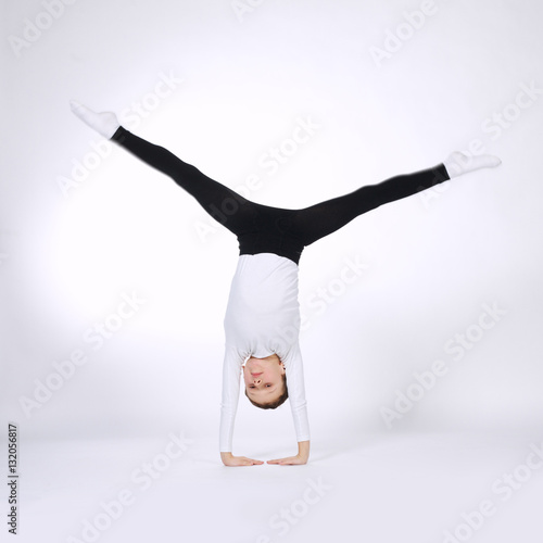 Fototapeta Naklejka Na Ścianę i Meble -  young gymnast on white background