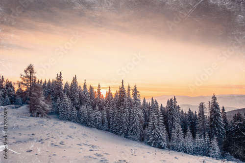 Magic sunset in the snowy mountains. Vintage effect