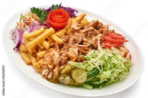 Doner kebab on a plate with french fries and salad