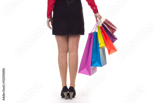 Woman wearing short black skirt and high hills from her back hol