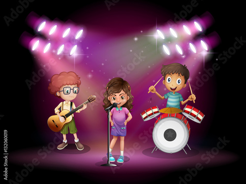Three kids playing music on stage