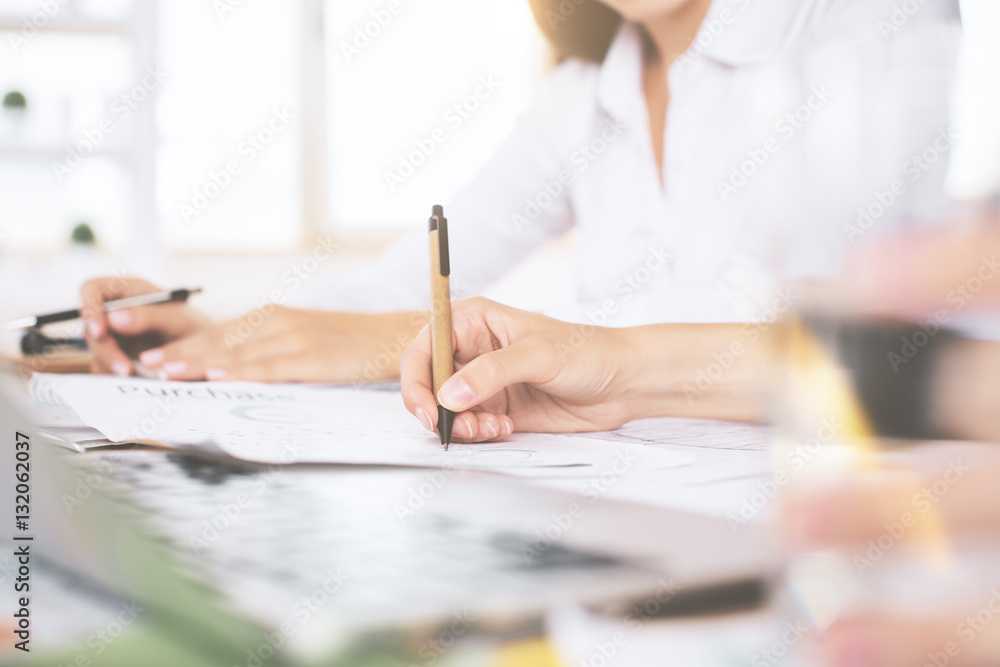 Hands doing paperwork and using laptop Hands doing paperwork and using laptop