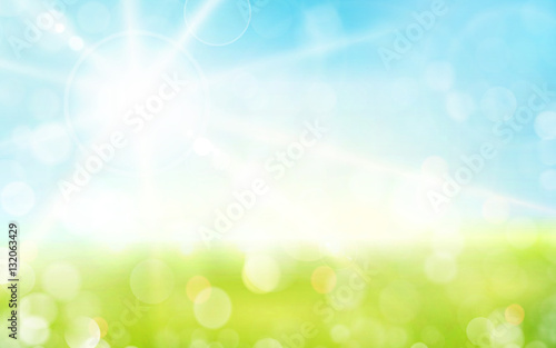 Light green, blue spring background with sun shine and blurry li