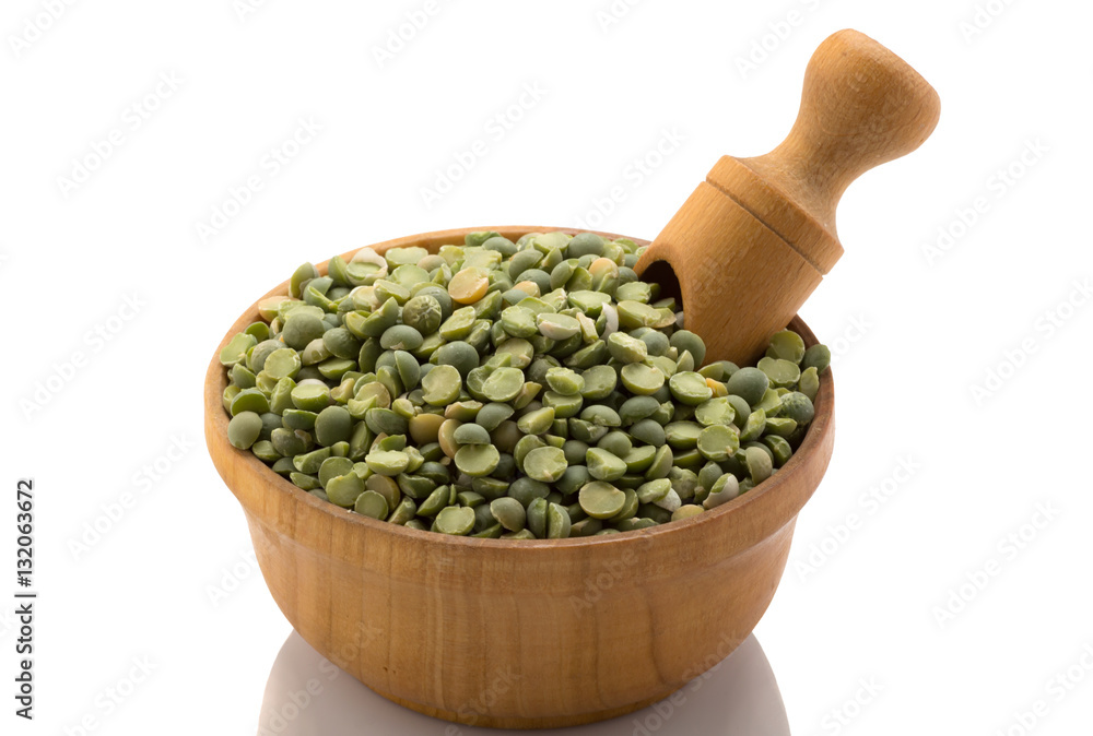 Green peas in a wooden bowl with a spatula Green peas in a wooden bowl with a spatula
