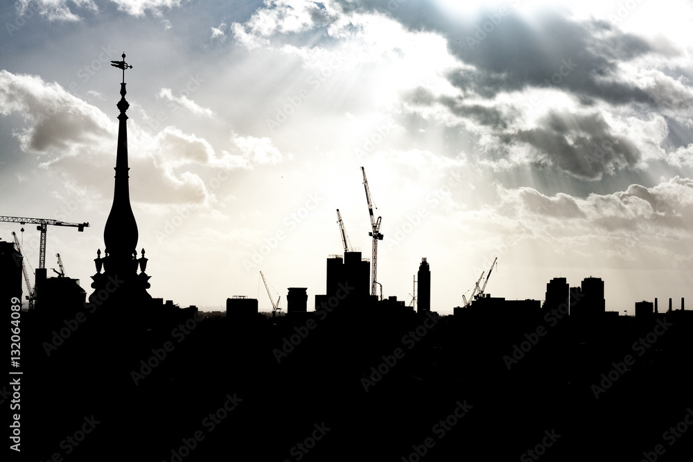 London city skyline with dramatic sunburst and clouds