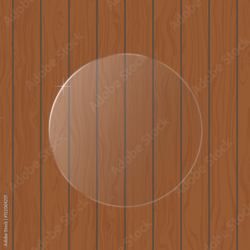 Round glass on a wooden background.