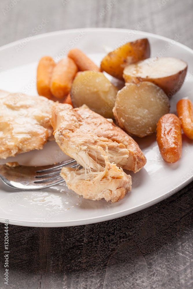 Garlic maple chicken with potatoes and carrots vertical shot Garlic maple chicken with potatoes and carrots vertical shot