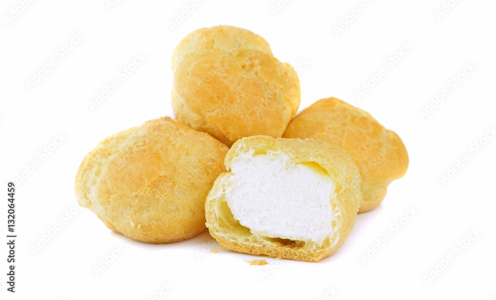 A pile of fresh cream puff pastries on a white background