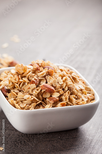 Homemade Nutty Cinnamon Granola with Honey in a small square white bowl