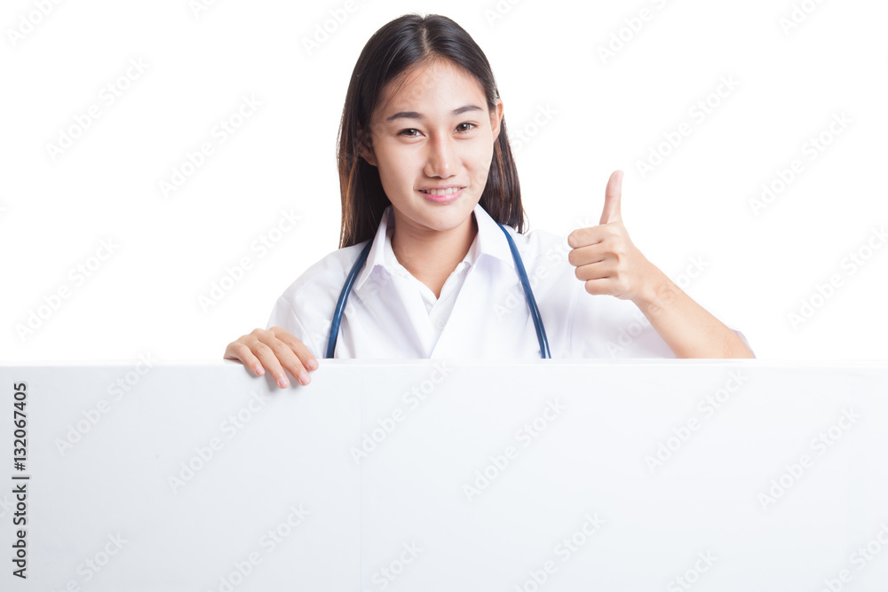 Young Asian female doctor show thumbs up behind blank white bil Young Asian female doctor show thumbs up behind blank white bil