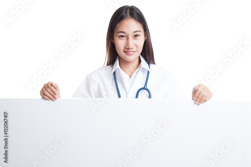 Young Asian female doctor show thumbs up  behind blank white bil