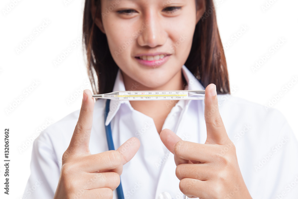 Young Asian female doctor with thermometer focus on thermometer. Young Asian female doctor with thermometer focus on thermometer.