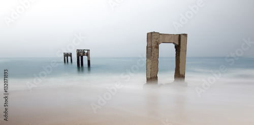 Abandoned Davenport Pier Beach. Davenport Pier Beach on a typical overcast summer day, Davenport, Santa Cruz County, California, USA. photo