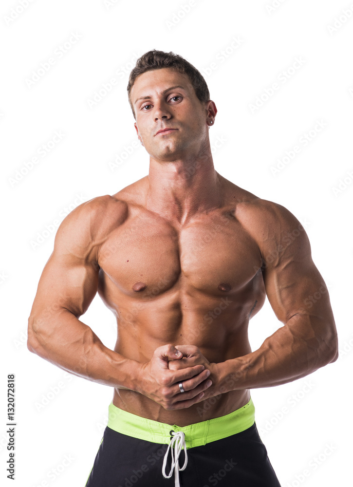 Fototapeta premium Handsome shirtless bodybuilder looking at camera, isolated on white background