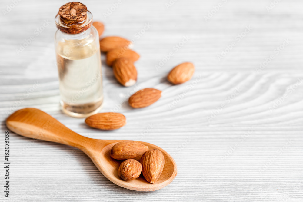 cosmetic almond oil in glass bottle on wooden background Stock-Foto