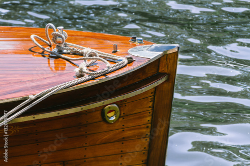 Detail of the wooden deck of a boat moored on dock
