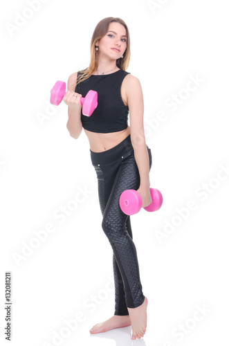 .Diet. Young beautiful girl with pink dumbbells in his hands. Girl performs sporting exercise. © salomonus_