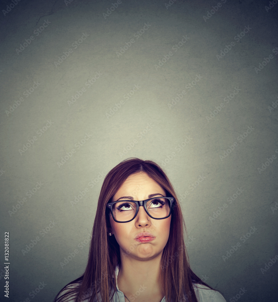 Annoyed young skeptical woman looking up Annoyed young skeptical woman looking up