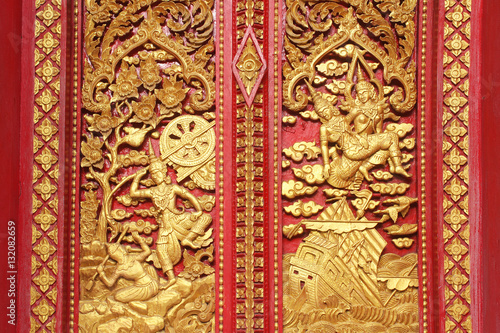 wooden carving sclupture of Ramakien Performance in the middle of heaven forest, the glory of Rama story decorated painted with gold leaf and red painting color, poster wallpaper background © biggereye