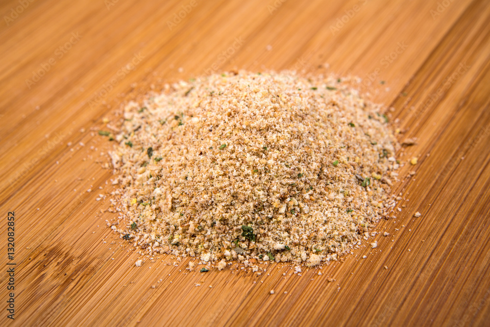 Seasoned italian bread crumbs isolated on a wood background Seasoned italian bread crumbs isolated on a wood background