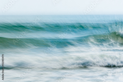 Coastal abstract motion blurred ocean waves blue tones background