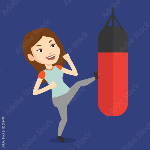 Woman exercising with punching bag.