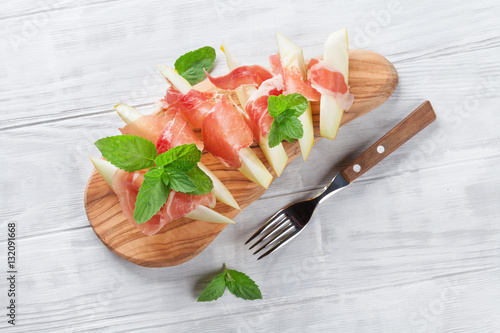 Fresh melon with prosciutto and mint photo