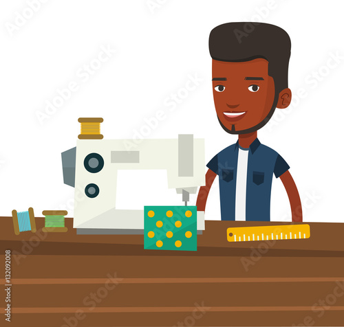 Male seamstress using sewing machine at workshop.