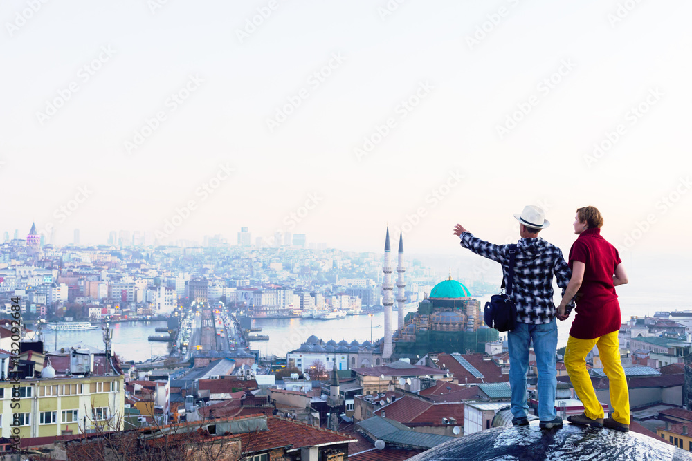 Man and Woman in casual travel Clothing on roof of Building