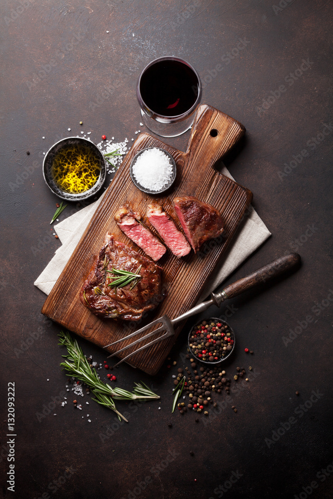 Fotografie Grilled ribeye beef steak with red wine