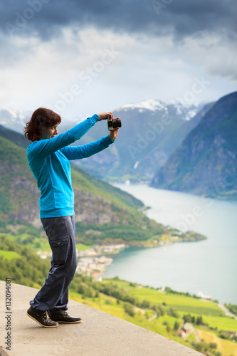 Female tourist taking photo at norwegian fjord © anetlanda