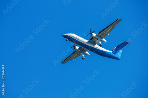 wide-body plane is flying in blue sky