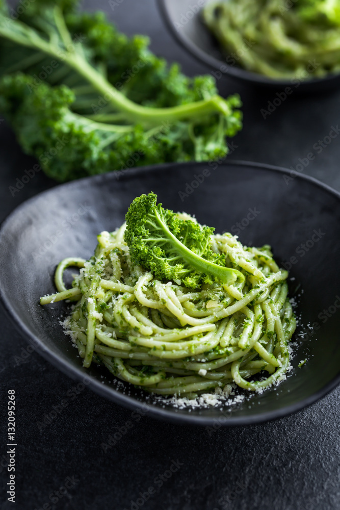 spaghetti pasta with  kale pesto sauce and parmesan cheese