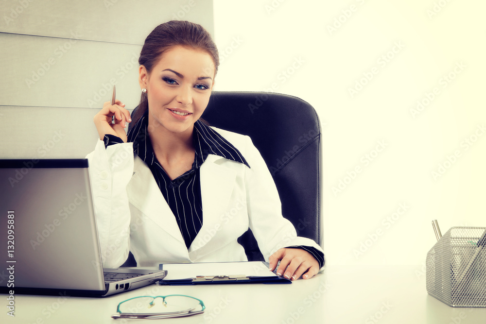 Attractive businesswoman working with laptop at the office
