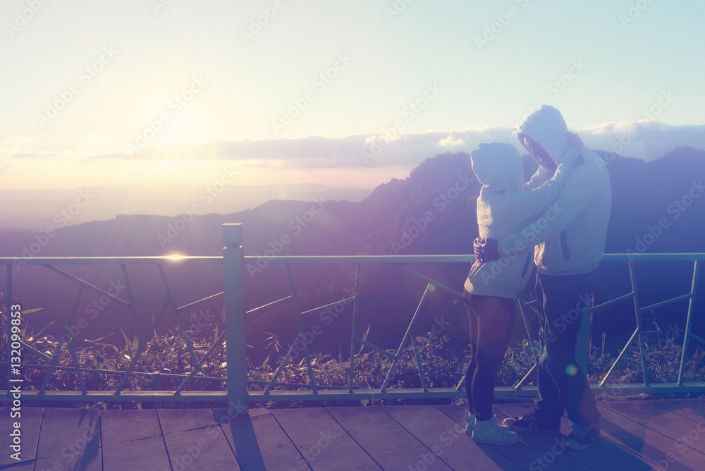 Fototapeta premium Silhouette of couples happy at scenic mountain fog and sun.