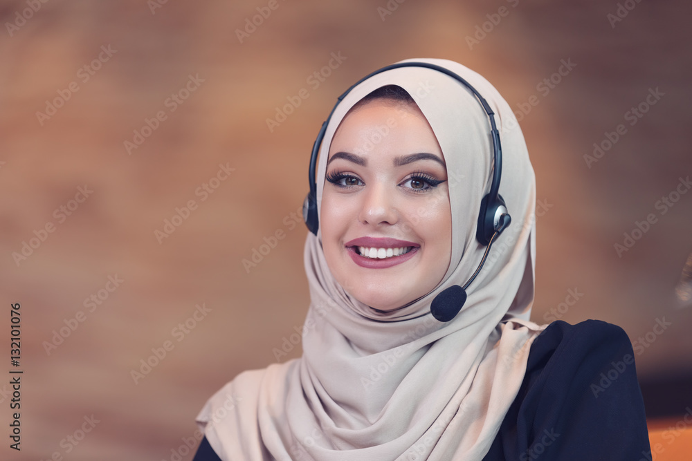 Beautiful phone operator arab woman working in startup office Beautiful phone operator arab woman working in startup office