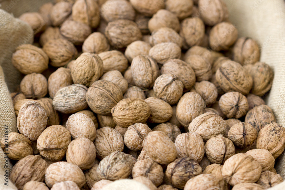 Background image of a basket full of a raw walnuts. Background image of a basket full of a raw walnuts.