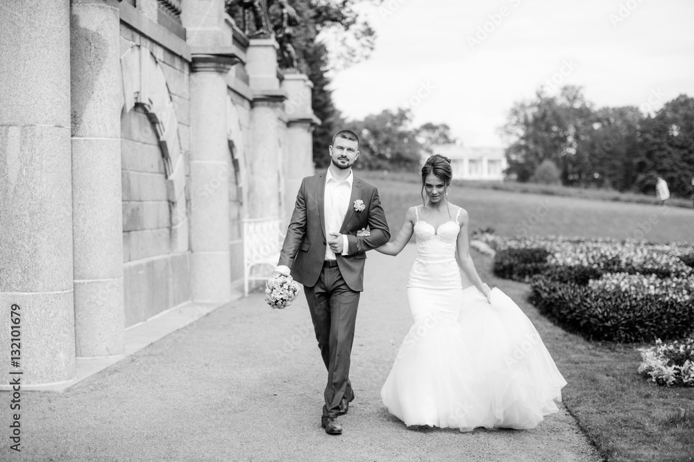 Young wedding couple enjoying romantic moments outside on a summer meadow Young wedding couple enjoying romantic moments outside on a summer meadow