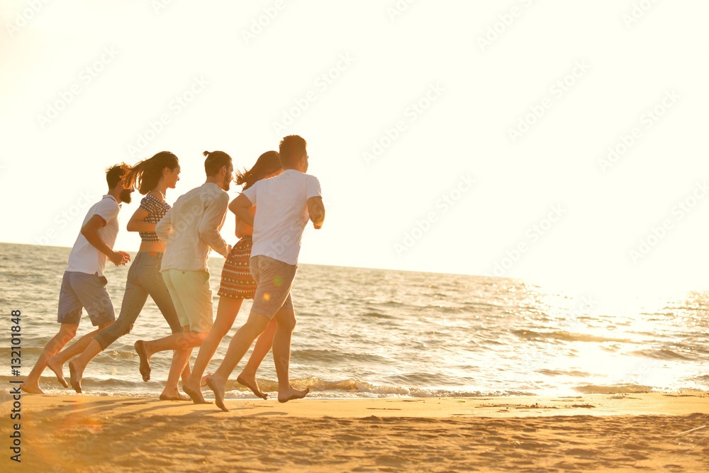 happy young people group have fun white running and jumping on beacz at sunset time happy young people group have fun white running and jumping on beacz at sunset time