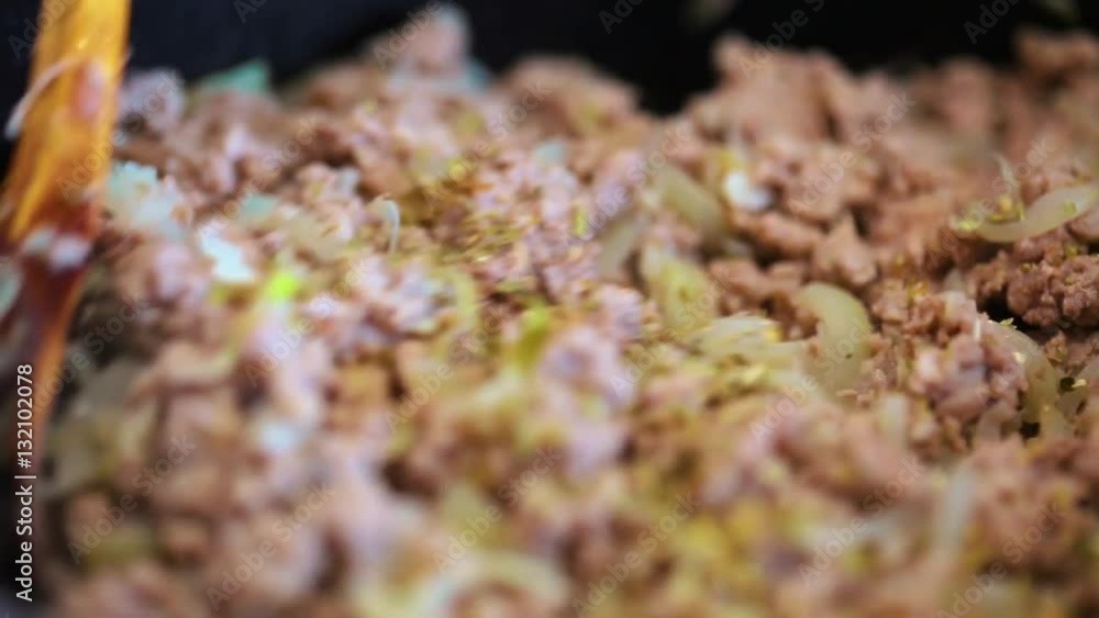 Mixing the lasagna meat filling in the frying pan Mixing the lasagna meat filling in the frying pan