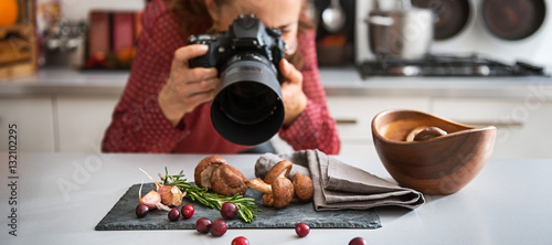 Woman food photographer taking closeup of mushrooms photo