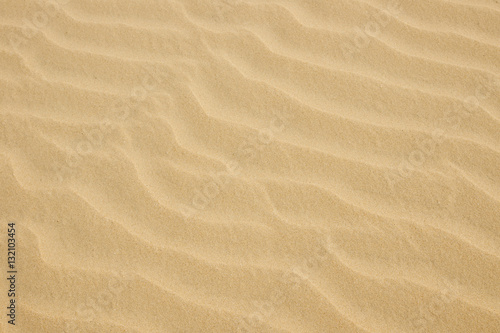 closeup of yellow sand pattern on a beach in the summer