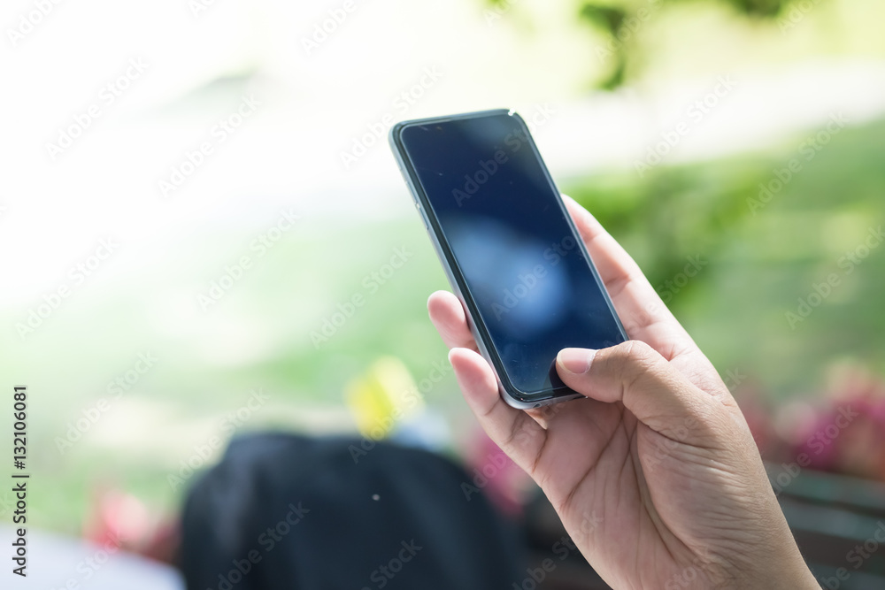A male(man) hand hold(touch) and looking at smart phone  in the